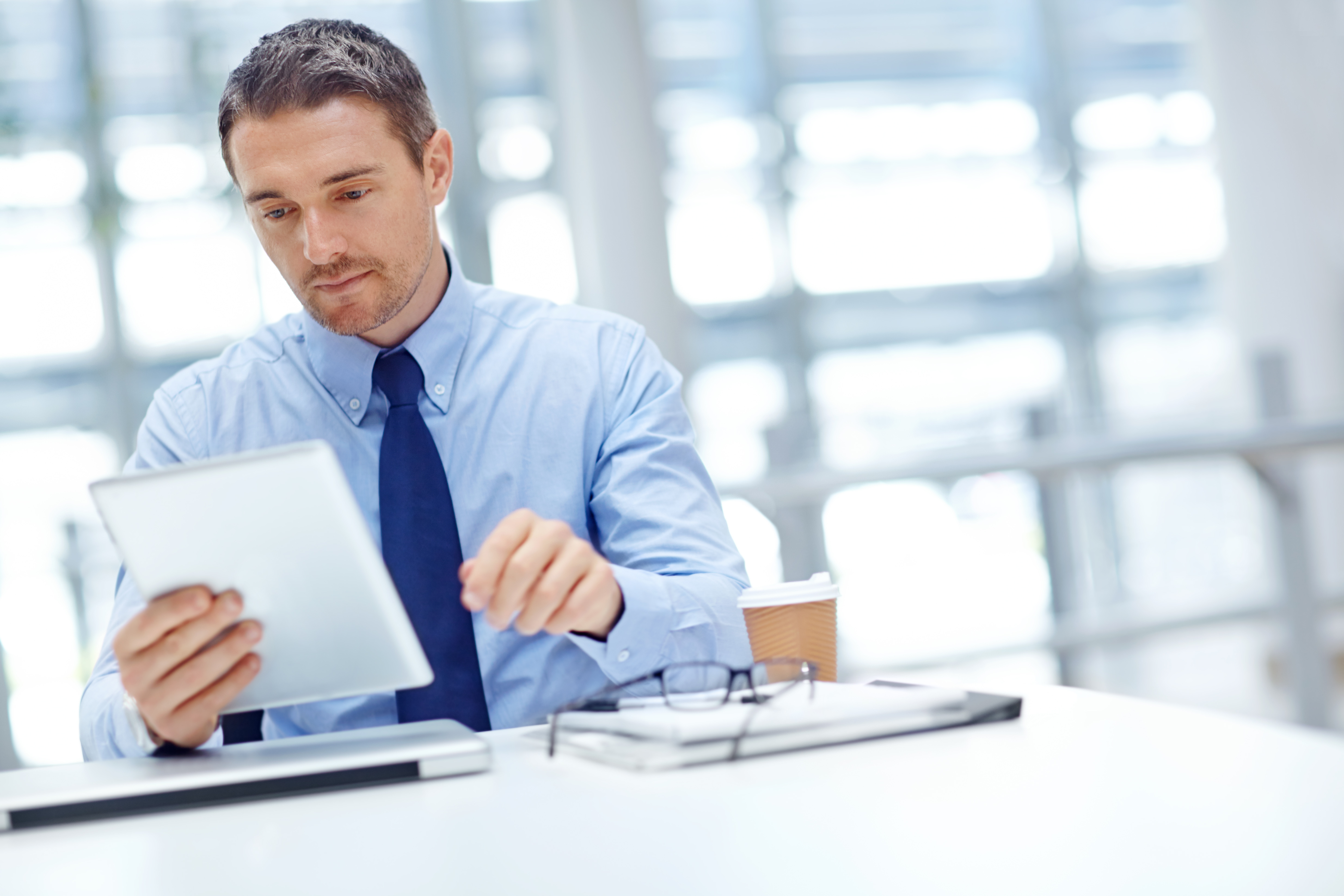 Businessman with tablet at office table